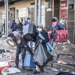 Looters take away items left in a vandalised mall in Vosloorus