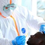 A medic collects samples from a man for Covid-19 testing.