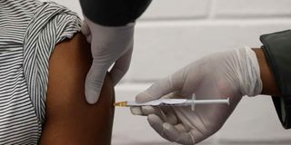 A health worker administers a Covid-19 vaccine.