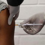A health worker administers a Covid-19 vaccine.