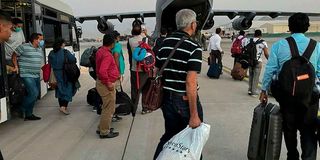 Indians prepare to board an Indian military aircraft 