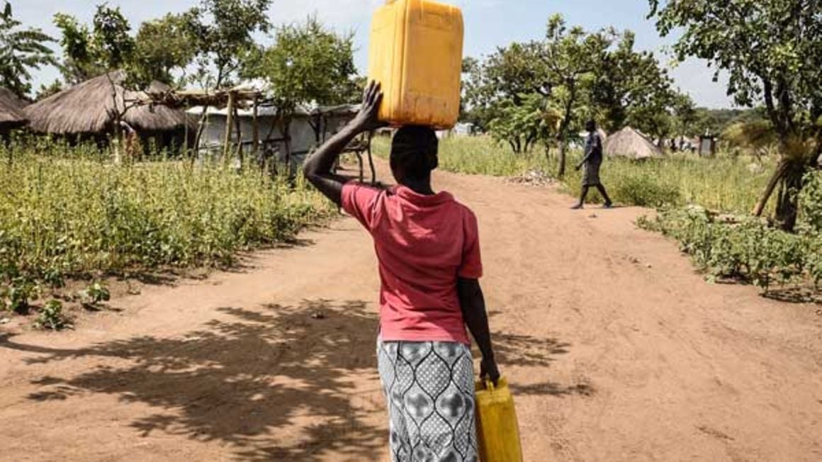 A South Sudanese refugee carries water at the Bidi Bidi refugee settlement in northern Uganda.