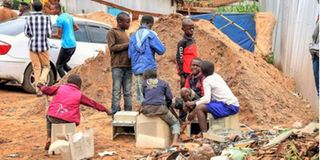 Children play with discarded computer components.