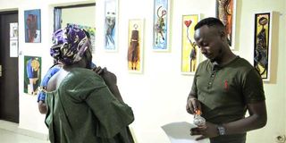 Art enthusiasts at an exhibition in Kigali, Rwanda.
