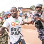 Police arrest an opposition supporter in Kampala.