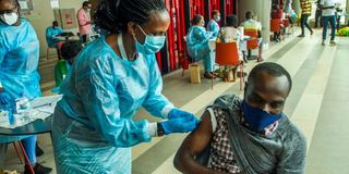 Health workers administer Covid-19 vaccines in Rwanda.
