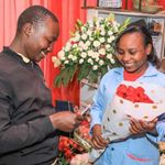 A man buys flowers at a shop.