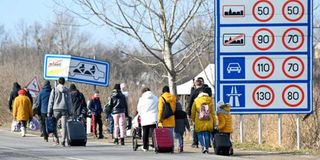 People flee the conflict in Ukraine to the Hungarian-Ukrainian border crossing near Beregsurany.