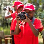 Children practise photography.