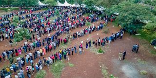 Residents queue to cast their votes at the Kenyatta Sports Ground polling station in Kisumu County.