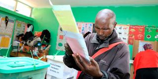 A man prepares to cast his ballots on August 9, 2022