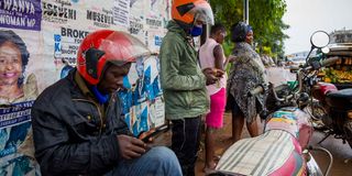 People using internet on their phones in Uganda