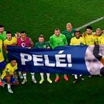 Brazil's players hold a banner dedicated to Pele