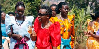 Women dressed in colourful gomesi