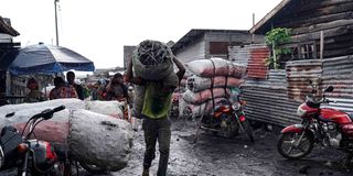 A man carries a bag of charcoal in Goma