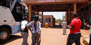 Passengers arriving in Kenya from Uganda at the Busia border