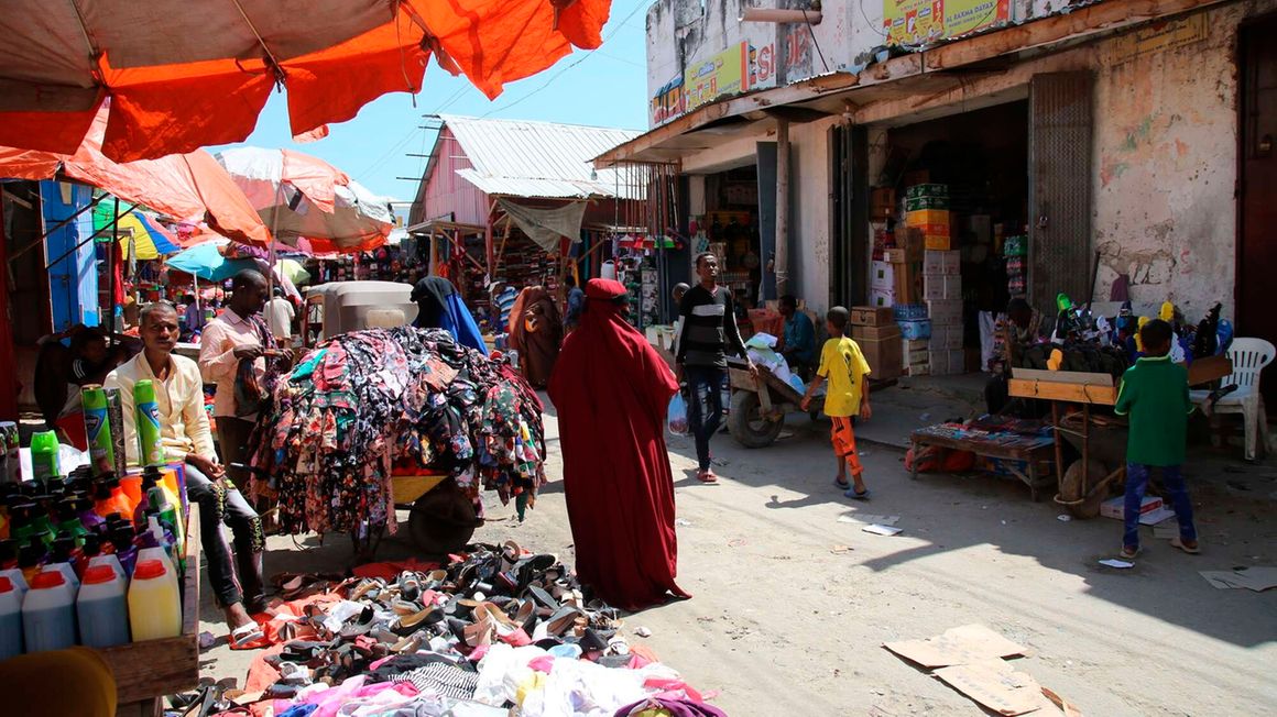 People walk in a street in Mogadishu, Somalia