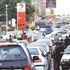 Motorists queue for petrol at a filling station in Nigeria
