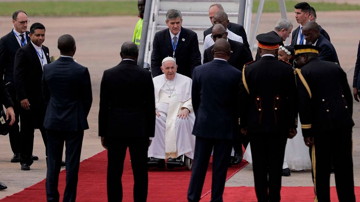 Pope Francis alights from his plane at the N'djili International Airport