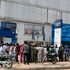 People queue to withdraw money in Kano