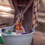 A domestic worker washing clothes
