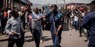 Congolese policemen escort a convoy 