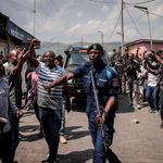 Congolese policemen escort a convoy 