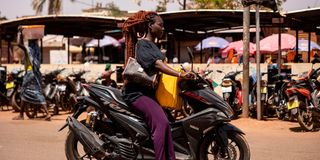 A woman rides a motorcycle in Burkina Faso 