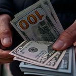 Dollar bills being counted