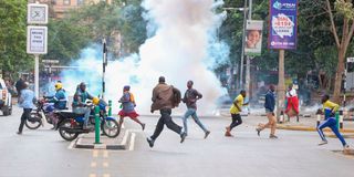 People run for cover after police threw tear gas 