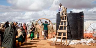 Somali refugees wait for water at Dadaab