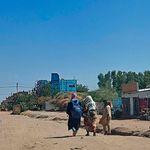 People walk along a deserted street in southern Khartoum