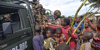 Kenyan soldiers with residents of Kiruma in DR Congo