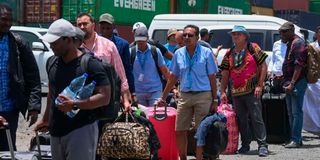 People fleeing the Sudan conflict queue to board a boat from Port Sudan