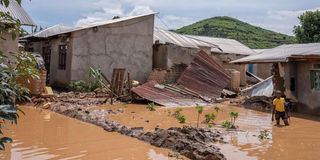 A boy wades through flood waters in Rwanda