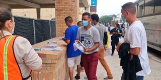 Migrants pick up their belongings in Brownsville, Texas